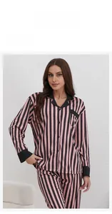 Close-up of pink and black striped knit cotton pajamas with contrast piping detail