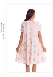 Detail of pink cotton nightgown featuring tiered layers and peach prints for women