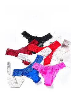Flat lay of lace thongs set in various colors with bow details and scalloped edges