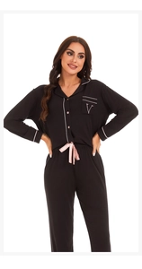 Detail of black pajamas with pink piping and silk ribbon bow at the waistline