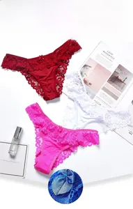 Detailed view of delicate wave lace trim and romantic bow on colorful thong set