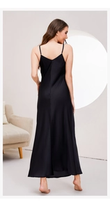 Detail view of smooth black satin nightgown showing the elegant deep V-back cut