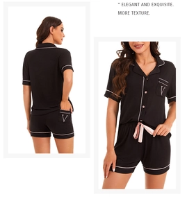 Detail of modal pajamas with white piping, chest embroidery, and pink satin drawstring