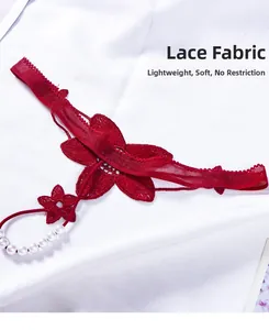 Detail of red lace thong featuring floral embroidery and white pearl beaded strap
