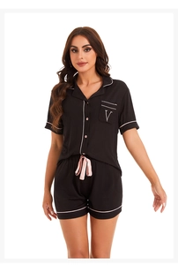 Detail of black modal pajamas with contrast piping and satin drawstring waist