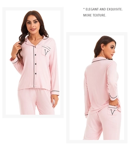 Close-up of pink modal pajama set with black piping and V-logo embroidered pocket