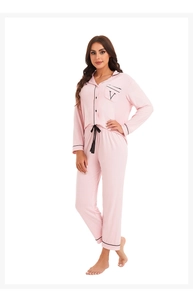 Detail of pink modal pajamas showing black piping, v-letter pocket and drawstring waist