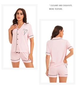 Detail of pink modal pajamas showing contrast piping and V embroidery on pocket