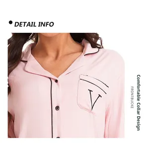 Detail of pink modal pajamas featuring a classic lapel collar with black piping trim