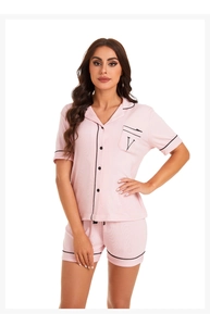 Detail of pink modal pajamas set featuring short sleeves with black contrast piping