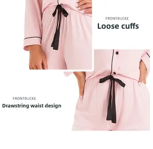 Detail of pink pajama loose cuffs and drawstring waist with black contrast piping trim