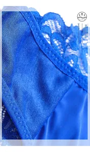 Macro detail of breathable inner crotch on dark blue lace thong with floral embroidery