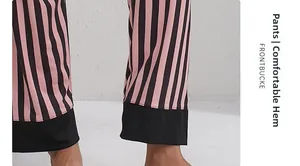Close-up of pink and black striped pajama pants featuring soft fabric and stitched black hem