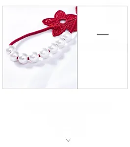 Detail of red lace floral embroidery with premium white pearls on thin elastic strap