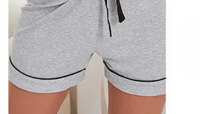 Close-up of light gray modal shorts featuring black piping and adjustable drawstring