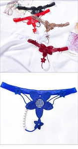 Detail of floral lace embroidery and elegant white pearl string on sexy low-rise T-back panties