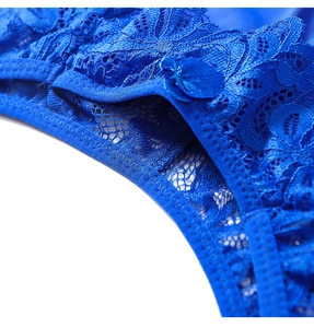 Detailed close-up of dark blue floral lace underwear with a small satin bow detail
