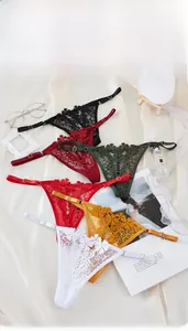 Flat lay of lace thong underwear set in six colors on elegant silk background