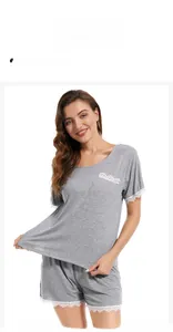 Detail view of grey modal sleepwear with delicate white lace trim on cuffs and hem