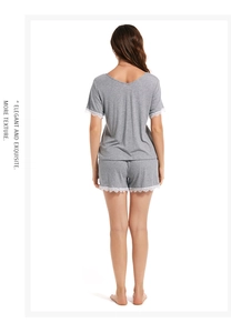Rear view of grey modal pajamas with white lace trim on sleeves and shorts
