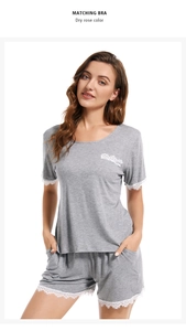 Detail view of grey modal pajamas with delicate white lace trim on sleeves and pockets