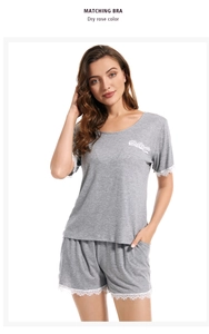 Detail of light grey modal pajamas featuring elegant white lace trim on sleeves and hem