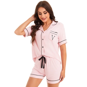 Pink modal cotton pajama set with short sleeves, black piping, and drawstring shorts