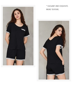 Close-up of black modal sleepwear set with white lace trim and practical side pockets