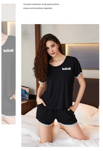 Detailed view of black modal pajama set with elegant white lace trim on sleeves and hem