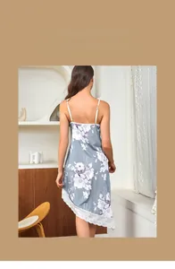 Detailed view of floral silk nightdress with white lace trim and asymmetric hem design