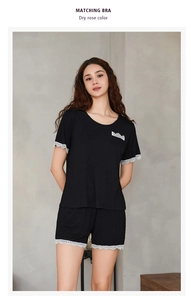 Detail of the black modal pajamas set featuring delicate white lace trim on the collar and hem
