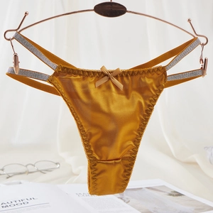 Golden satin lace thong for women featuring glitter side straps and bow decoration
