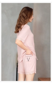 Detail of pink loungewear set with lace trim and ribbed fabric on the shorts