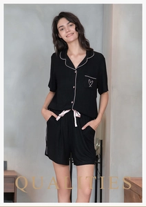 Close-up of ribbed texture and heart embroidery on black modal pajama shorts set