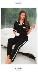 Détail de pyjama en modal noir à côtes avec liseré rose et broderie V sur la poche