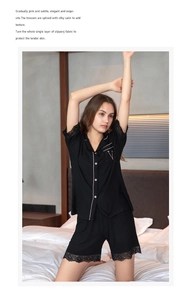 Detail of lace trim on black modal pajamas with pink contrast piping and V-pocket