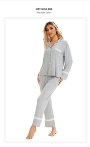 Detailed close-up of grey long-sleeved pajamas with delicate white lace trim on sleeves