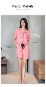 Detail view of pink modal pajama set with heart pocket and black contrast piping