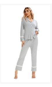 Detail of grey pajama set featuring delicate lace trim on sleeve cuffs and pant hems