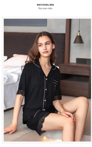 Detail view of black modal pajamas set featuring lace trim and dry rose contrast piping