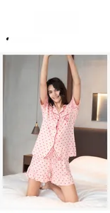 Detailed view of pink modal pajama set with red heart prints and ruffle hem shorts