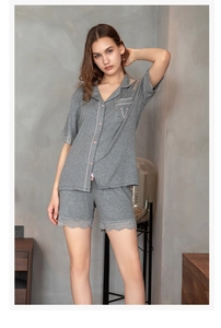 Close-up of grey ribbed modal loungewear with lace trim and pink contrast piping