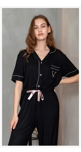 Detail of modal ribbed pajama set with pink piping and satin bow at waist