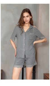 Detail of grey modal pajama set with pink piping and delicate lace trim on hem