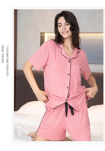 Detail of pink lounge set showing contrast piping, ribbed texture, and button-up shirt collar