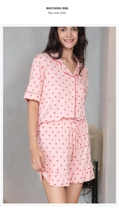 Detail view of dry rose modal pajamas with red heart prints and ruffle hem shorts