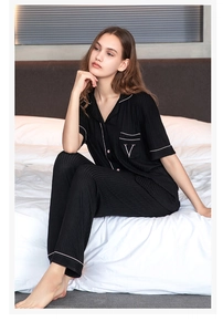 Close-up of black modal striped pajamas set with white piping and embroidered V detail