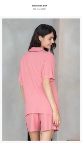 Detail view of dry rose color rib-knit pajama set with elegant black piped edges and soft drape