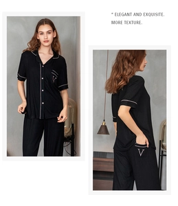 Detail of black striped pajama set with contrast pink piping and embroidered V pocket logo