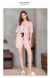 Detail of dry rose modal pajamas featuring lace trim on sleeves and black bow tie waistband